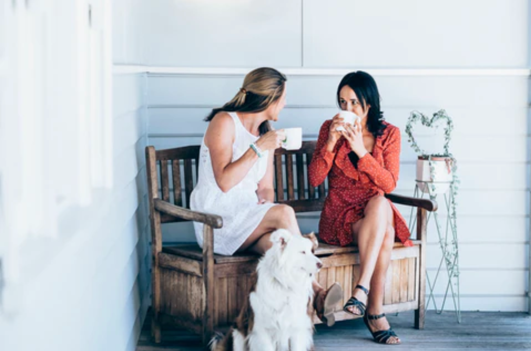 2 women sitting and drinking warm drinks